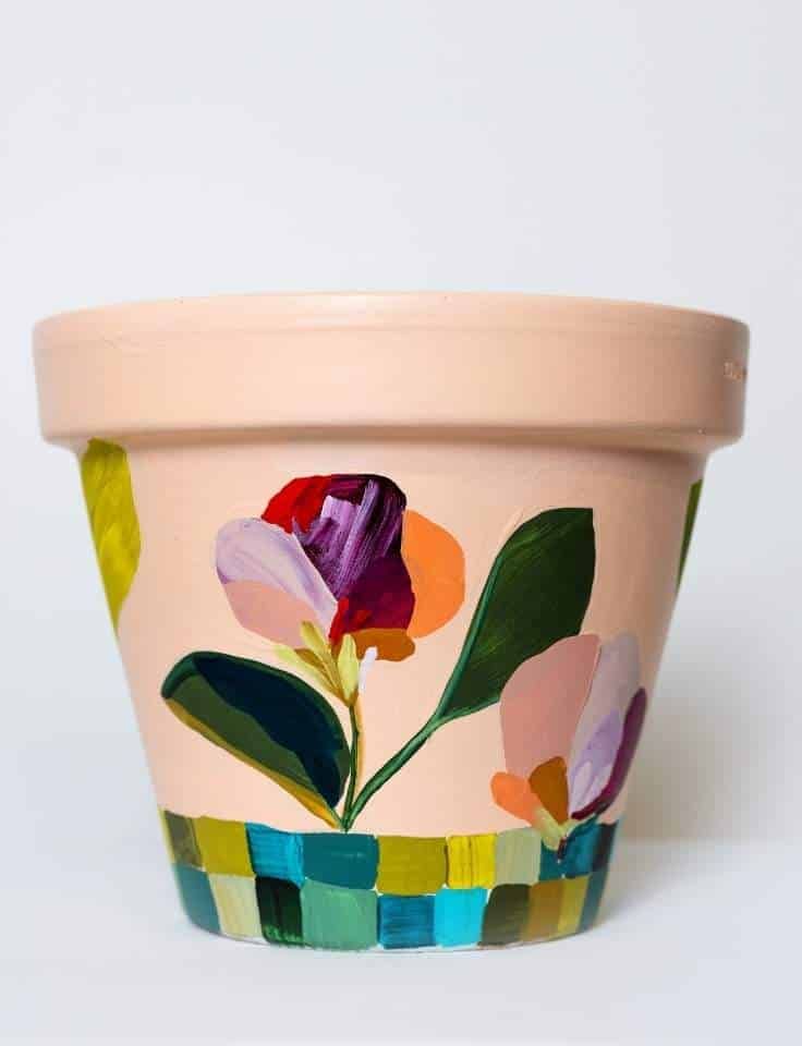 Pinot & Picasso Love Grows is a plant pot with painted leaves and shapes onto the pot.