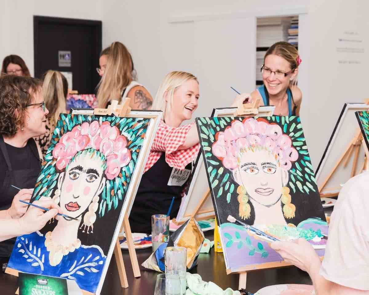 a group of women painting an artwork of Frida kahlo on canvas at Pinot and Picasso